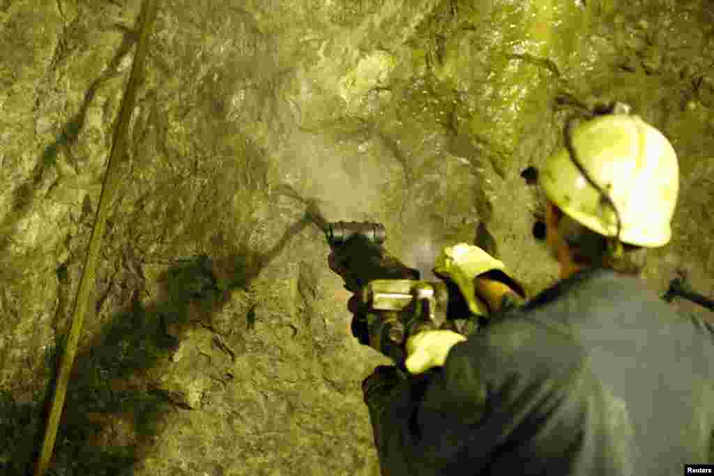A miner drills for copper.