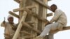 Iraqis work on a reconstruction project in Baghdad in August.