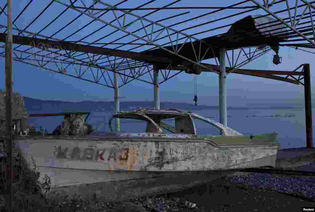 An abandoned boat on a beach in Sukhumi