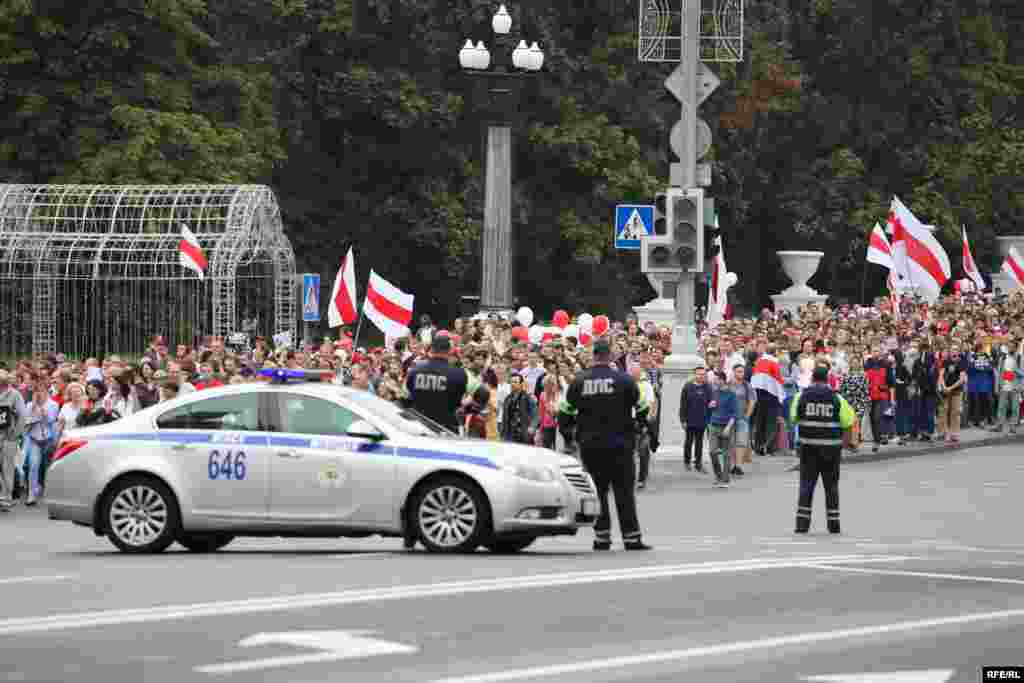 Police watch as protesters make their way toward the central rallying point on Independence Square.&nbsp;