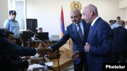 Armenia -- Karabakh President Bako Sahakian (C) and his predecessor Arkadi Ghukasian (R) shake hands with prosecutors during former Armenian President Robert Kocharian's trial in Yerevan, May 16, 2019.