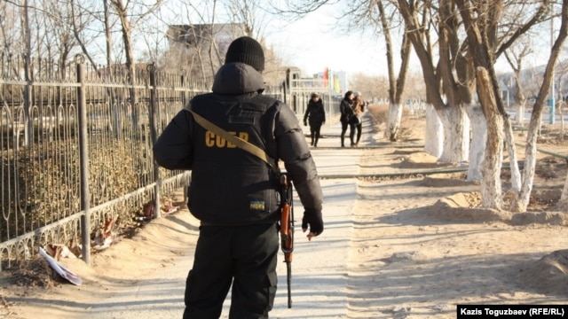 A police officer stands guard in Zhanaozen in the days after the December 2011 violence.