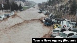 Vehicles are stacked one against another after a flash flooding In Shiraz, Iran, March 25, 2019. 