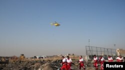 Rescue team works among debris of a plane belonging to Ukraine International Airlines, Tehran, Iran January 8, 2020