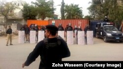 Karachi police officers guard the roads leading to the French Consulate after a protest against the French satirical magazine "Charlie Hedbo" turned violent in January.