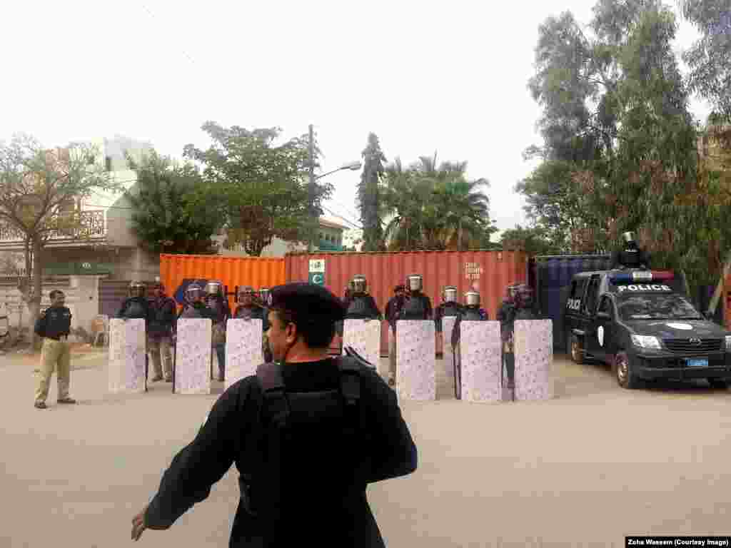 Karachi police officers guard the roads leading to the French Consulate after a protest against the French satirical magazine "Charlie Hedbo" turned violent in January.