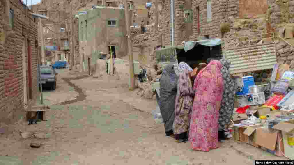 Women shop at a roadside stall.