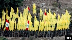 Pjesëtarë të grupit Hezbollah duke dëgjuar fjalimin e udhëheqësit të tyre në Liban. Gusht 2015.
