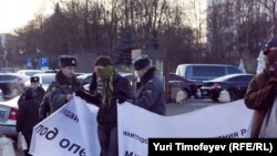 Policemen detain activists during an unsanctioned rally to mark World AIDS Day in Moscow.