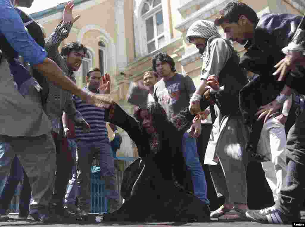 Afghan artists perform a reenactment on April 27 of the lynching of Farkhunda -- a 27-year old woman who was killed by a mob for allegedly burning the Koran -- to protest against her death in March in Kabul. (Reuters/Omar Sobhani)