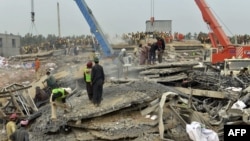Pakistani rescuers search for victims in the rubble of a collapsed factory on the outskirts of Lahore on November 6.