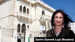 Maltese investigative journalist Daphne Caruana Galizia poses outside the Libyan Embassy in Valletta in April 2011.