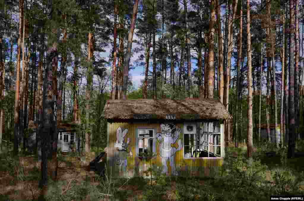 The feeling one gets in the exclusion zone today, though, is mostly one of sadness. Far removed from the monstrous mismanagement that led to the catastrophe were ordinary people who took pride in their town. The brightly painted murals of this children&#39;s camp are rotting away one by one into the forest.