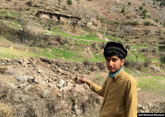A resident points to the site where Indian jets reportedly struck in Balakot.