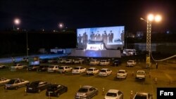A "eulogist of Imams" holding a "drive-in" Ramadhan ceremony at the parking lot of a Tehran leisure complex. April 29, 2020.