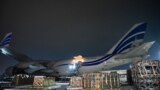 Workers unload a shipment of military aid delivered as part of U.S. security assistance to Ukraine, at Boryspil airport outside Kyiv on January 25.