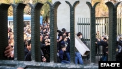 Iranian students clash with riot police during an anti-government protest around the University of Tehran, Iran, 30 December 2017