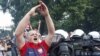 A Polish soccer fan is moved by riot police protecting Russian fans marching to the National Stadium in Warsaw.