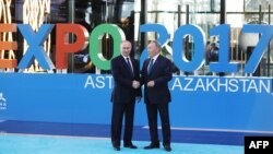 Russian President Vladimir Putin (left) shakes hands with Kazakh counterpart Nursultan Nazarbaev as they attend the opening of the Expo 2017 in Astana on June 9.