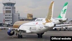 A Mahan airlines plane alongside Qatar airways in Mashhad International airport, undated. FILE PHOTO