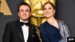 Former NASA scientist Firouz Naderi and engineer/astronaut Anousheh Ansari pose with the Best Foreign Language Film award for The Salesman on behalf of director Asghar Farhadi at the Oscars on February 26.