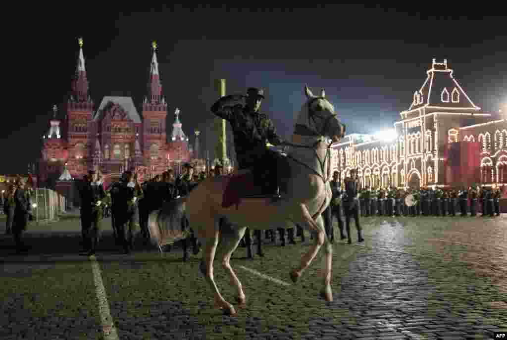 Also preparing for Victory Day celebrations, a Turkmen soldier rides a white Akhel-Teke horse during a parade rehearsal on Red Square in Moscow. Photo by Michael Eckels for AFP