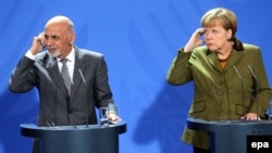 German Chancellor Angela Merkel (R) and Afghan President Ashraf Ghani take part in a press conference at the Federal Chancellery in Berlin on December 5.