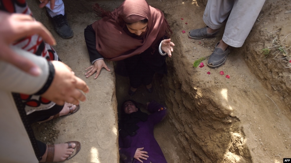 Violence against women remains a major issue in Afghanistan. File photo of Afghan civil society activist women weep and lie on the grave of Farkhunda, 27 after she was lynched by an angry mob in central Kabul on March 22.