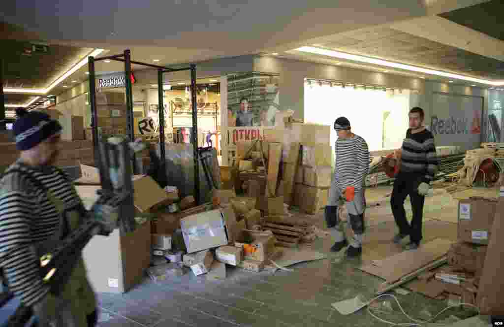 Workers walk through an unfinished shopping mall on February 2.