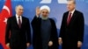 Turkish President Recep Tayyip Erdogan (right), Iranian President Hassan Rohani (center), and Russian President Vladimir Putin greet the media during a trilateral summit in Tehran on September 7. 