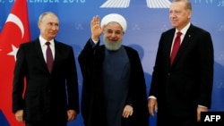 Turkish President Recep Tayyip Erdogan (right), Iranian President Hassan Rohani (center), and Russian President Vladimir Putin greet the media during a trilateral summit in Tehran on September 7.