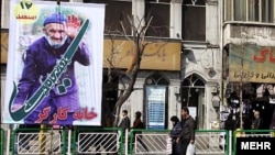 People walk past a billboard in Tehran for the upcoming parliamentary elections in Iran on March 2.