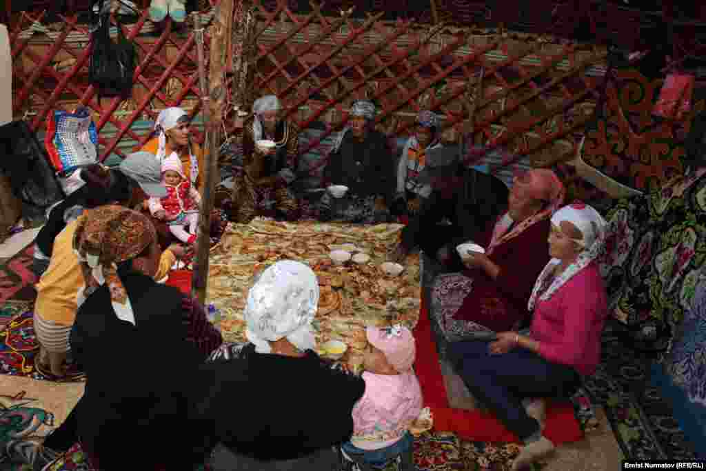 Guests gather to enjoy kumis together with fresh bread or &quot;boorsok,&quot; a type of fried dough.