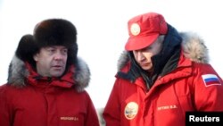 Russian President Vladimir Putin (right) and Prime Minister Dmitry Medvedev visit the remote Arctic islands of Franz Josef Land on March 29. 