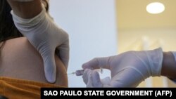 Еріктіге Қытайдың Sinovac Biotech компаниясы шығарған вакцинаны салып жатқан дәрігер. Көрнекі сурет.