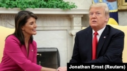 U.S. President Donald Trump greets UN Ambassador Nikki Haley in the Oval Office as the president accepted Haley's resignation on October 9.