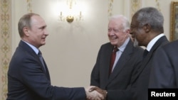 Russian President Vladimir Putin (left) meets with former U.S. President Jimmy Carter (center), former UN Secretary-General Kofi Annan, and other members of the Elders group at the Novo-Ogaryovo state residence outside Moscow on April 29.