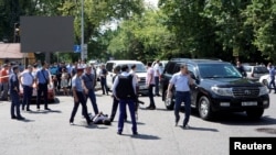 Police officers detain a man after an attack in the centre of Almaty, Kazakhstan on July 18, 2016. 