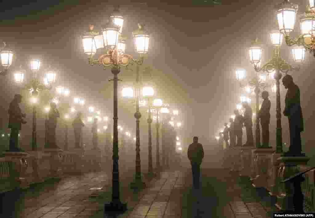A man walks over a bridge through dense fog and smog in the Macedonian capital, Skopje. (AFP/Robert Atanasovski)