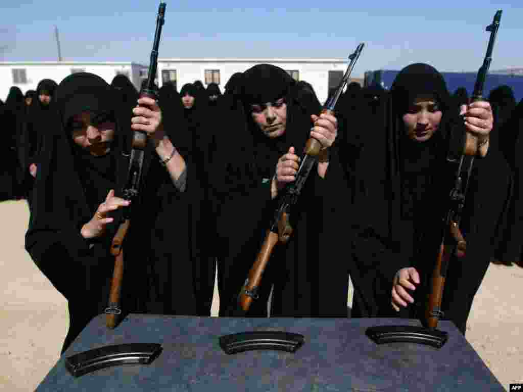 Iraqi female police cadets train on Ak-47 Kalashnikov machine guns in Karbala, south of Baghdad, on March 26, 2009. A car bomb ripped through a crowd in Baghdad on March 26, killing at least 16 people, including women and children, a day after the U.S. military said violence in Iraq was at its lowest in six years. top2009
