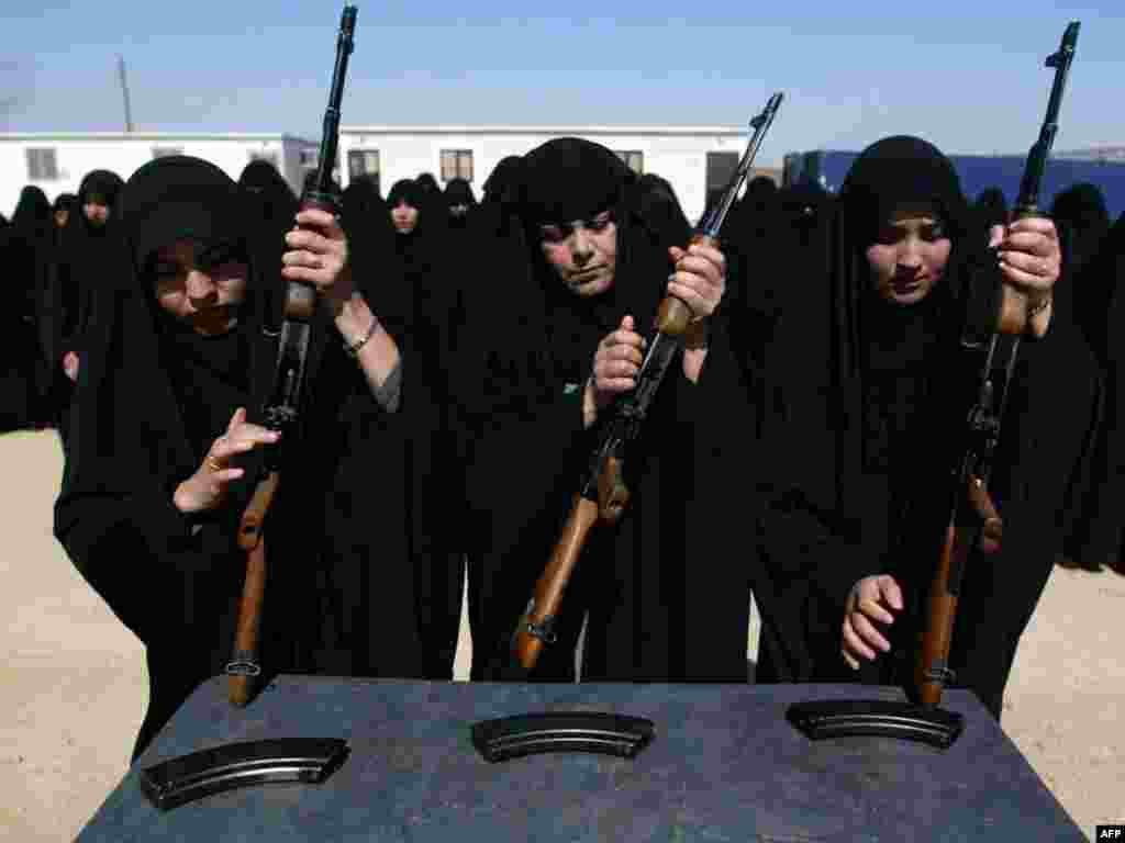 Iraqi female police cadets train with AK-47 machine guns in Karbala, south of Baghdad, on March 26.