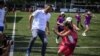 Former French football player Youri Djorkaeff plays with students of his childhood school on June 4, 2019 at the Charles de Rochefoucauld school in Lyon. (Photo by JEAN-PHILIPPE KSIAZEK / AFP)