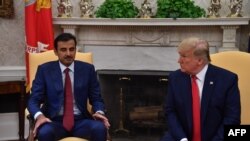 US President Donald Trump meets with the emir of Qatar Sheikh Tamim bin Hamad al-Thani in the Oval Office at the White House in Washington, DC, on July 9, 2019. 