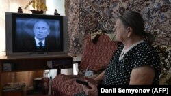 Ілюстраційне фото. Літня жінка дивиться «пряму лінію» президента Росії Володимира Путіна по телевізору