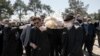 Mourners wearing face masks and gloves carry the body of former politburo official in the Revolutionary Guard Farzad Tazari, who died Monday after a battle with coronavirus in Tehran, March 10, 2020