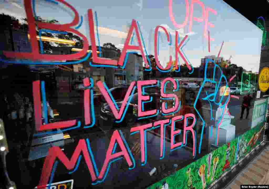 "Black Lives Matter" is written in a shop window in the Dorchester neighborhood of Boston, Massachusetts, U.S., June 18, 2020. 