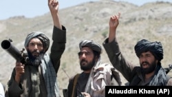 FILE: Taliban fighters react to a speech by their senior leader in the Shindand district of Herat province in May 2016.