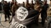 Iraqi soldiers pose with an Islamic State flag in the recaptured town of Al-Shura, south of Mosul, on October 30.