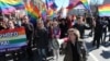 Natalya Tsymbalova (right foreground) leads a march by the Alliance of Heterosexuals for LGBT Equality in St. Petersburg.