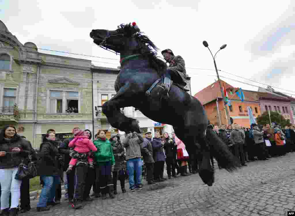 A man rides a horse during a parade on Hungary&#39;s National Day in Targu Secuiesc, Romania. Thousands of ethnic Hungarians from the central Transylvanian region of Romania gather in a celebration in Targu Secuiesc to mark the 1848 Hungarian Revolution. (AFP/Daniel Mihailescu)